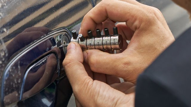 Professional locksmith working with car keys and brands